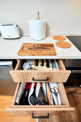 a drawer filled with lots of cooking utensils at Апартамент за гости Магнолия Резиденс in Sunny Beach
