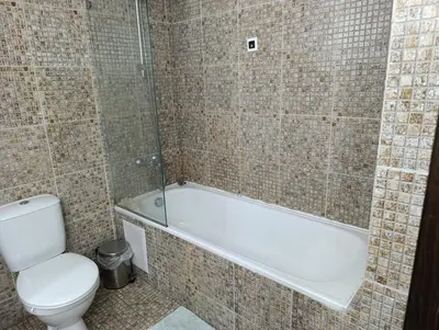 a bathroom with a toilet and a bath tub at Reina Apart Barcelo Beach in Sunny Beach