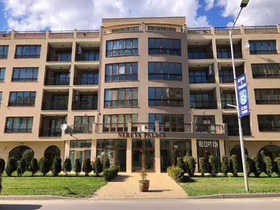 a large building with a sign in front of it at Nereya Studio in Pomorie