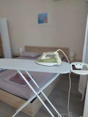 a hospital bed with a phone on a table at Nereya Studio in Pomorie