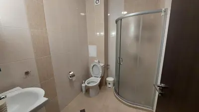 a bathroom with a shower and a toilet and a sink at Nereya Studio in Pomorie