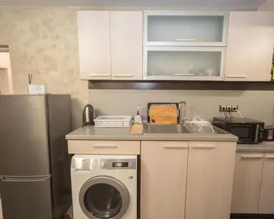 a kitchen with a sink and a washing machine at Aleks Holiday-center,sea,parking in Burgas City