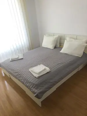 a bed with two white towels on top of it at Spacious, 2 Bed Apt, Fort Orchid in Sunny Beach