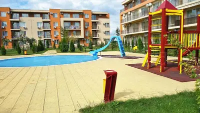 a playground with a slide in front of a building at Spacious, 2 Bed Apt, Fort Orchid in Sunny Beach
