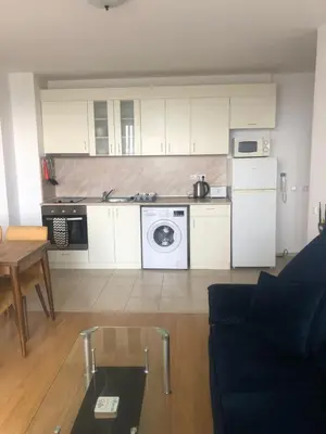 a kitchen and living room with a couch and a table at Spacious, 2 Bed Apt, Fort Orchid in Sunny Beach