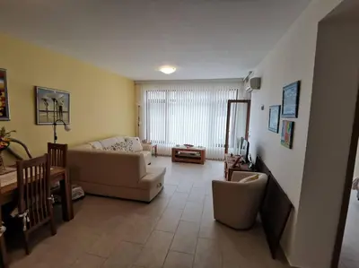 a living room with a couch and a table at Homely, 2 Bed Apt, 4* Vineyards in Kableshkovo