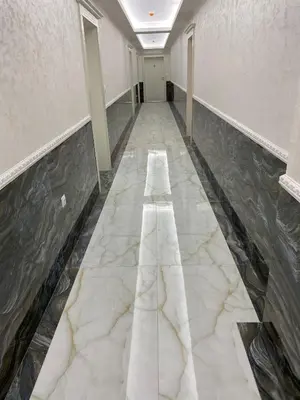 a hallway with a marble floor and a long white corridor at Luxury Penthouse Apartments at Valencia Gardens in Burgas City