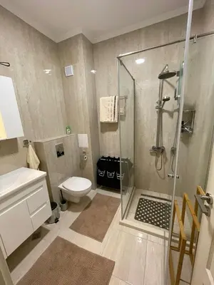 a bathroom with a shower and a toilet at Luxury Penthouse Apartments at Valencia Gardens in Burgas City