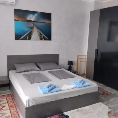 a bedroom with a bed with two towels on it at Luxury Penthouse Apartments at Valencia Gardens in Burgas City