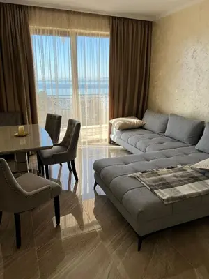 a living room with a couch and a table at Luxury Penthouse Apartments at Valencia Gardens in Burgas City