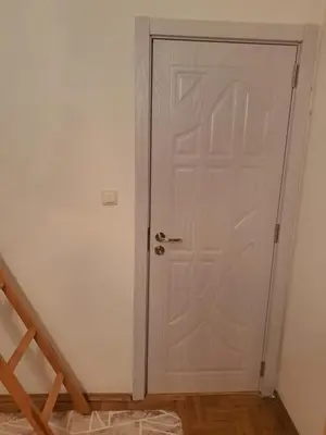 a white door in a room with a staircase at ПРИНЦЕС in Burgas City