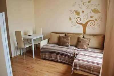 a bedroom with a bed and a table with a laptop at Plush, 1 Bed Apt, Dawn Park D in Sunny Beach