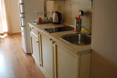 a kitchen counter with a sink and a refrigerator at Plush, 1 Bed Apt, Dawn Park D in Sunny Beach