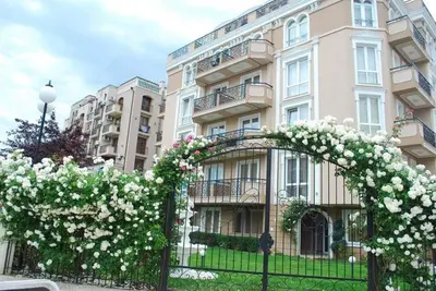 a building with a gate with white flowers on it at Plush, 1 Bed Apt, Dawn Park D in Sunny Beach