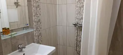 a bathroom with a sink and a mirror at Апартаменти Детелини in Primorsko