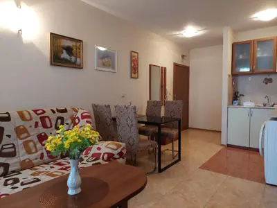 a living room with a couch and a table at Комплекс Элит 4 Несебр/Солнечный берег in Sunny Beach