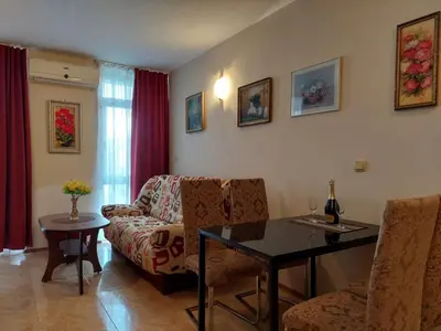 a living room with a couch and a table at Комплекс Элит 4 Несебр/Солнечный берег in Sunny Beach