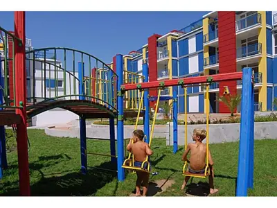 two young boys playing on a playground at Комплекс Элит 4 Несебр/Солнечный берег in Sunny Beach
