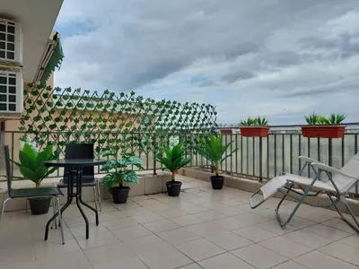 a balcony with a table and chairs and plants at Солнечный берег Grand Kamelia in Sunny Beach