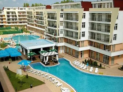 an apartment complex with a pool and a resort at Солнечный берег Grand Kamelia in Sunny Beach