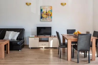a dining room with a table and a couch at Villa Entre in Emona