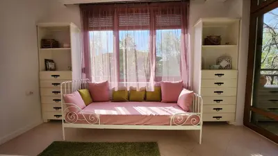 a room with a couch in front of a window at Nevena Summer Apartment by Santa Marina Sozopol in Sozopol