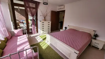 a bedroom with a pink bed and a mirror at Nevena Summer Apartment by Santa Marina Sozopol in Sozopol