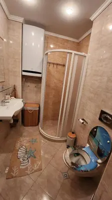 a bathroom with a shower and a toilet and a sink at Nevena Summer Apartment by Santa Marina Sozopol in Sozopol