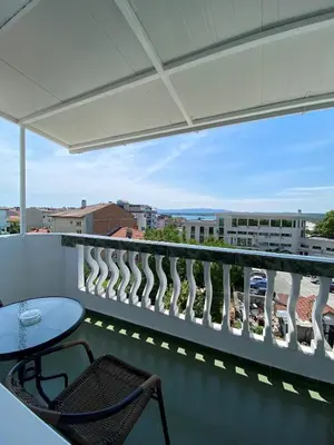 a balcony with a table and chairs and a view at Your Room Primorsko in Primorsko