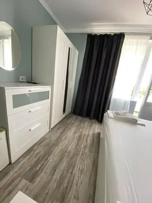 a bedroom with a bed and a dresser and a window at Your Room Primorsko in Primorsko