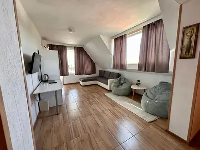 a living room with a couch and a tv at Your Room Primorsko in Primorsko