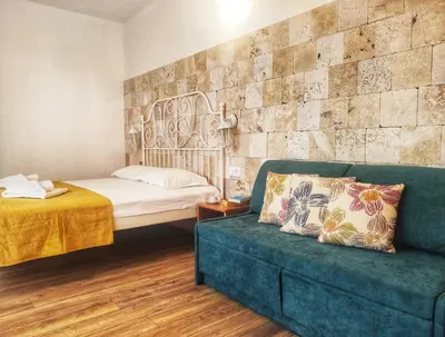 a room with a bed and a couch and a bed and a bed at Villa Meraki in Byala