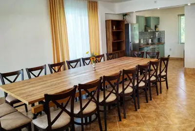 a large wooden table and chairs in a room at Villa Meraki in Byala
