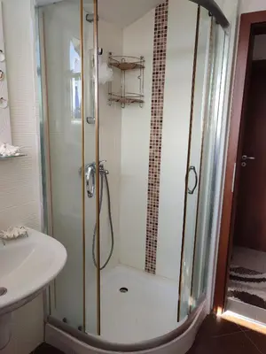 a bathroom with a shower and a sink at Созополски Рай in Sozopol