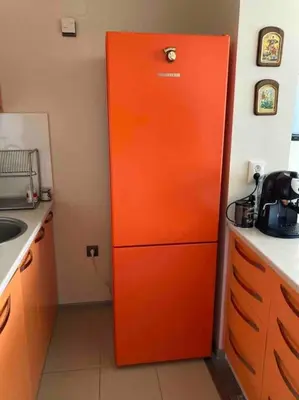 an orange refrigerator in the corner of a kitchen at Nessebar panoramic apartment in Nesebar