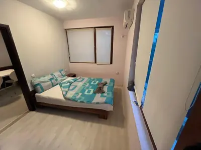a small bedroom with a bed in a room at Vqra Sarafovo in Burgas City