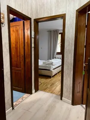 a room with two doors and a bedroom with a bed at Apart Zefira 2 Rooms in Varna City