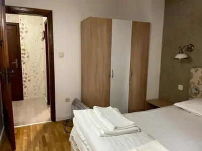 a bedroom with two beds and a door to a bathroom at Apart Zefira 2 Rooms in Varna City