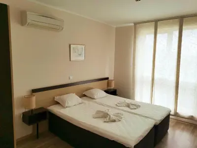 a bedroom with a large bed with towels on it at Апартамент Б306 в Обзор Бийч Резорт на първа линия с перфектен изглед към плажа! in Obzor