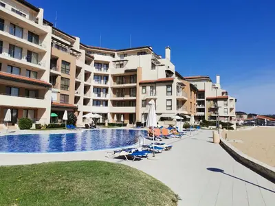 a hotel with a swimming pool next to a beach at Апартамент Б306 в Обзор Бийч Резорт на първа линия с перфектен изглед към плажа! in Obzor