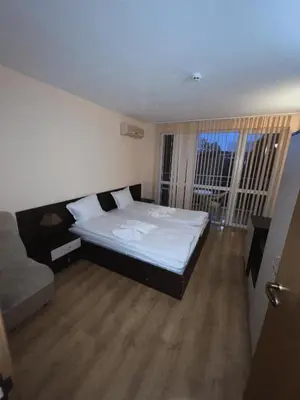a bedroom with a large bed and a couch at Residence Livi Paradise Sunny Beach! 2 plus 1 - 600m away from the beach in Sunny Beach