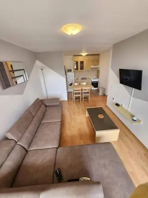 a living room with a brown couch and a table at Modern 1 Bed Apt, Nesebar Fort in Sunny Beach