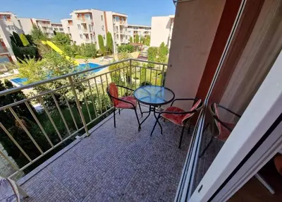 a balcony with a table and chairs on a balcony at Modern 1 Bed Apt, Nesebar Fort in Sunny Beach