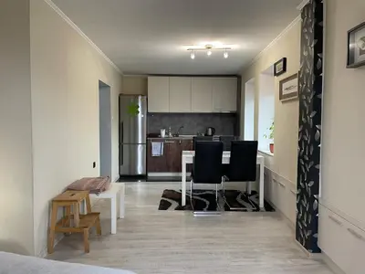 a kitchen and dining room with a table and chairs at Studio flat in the heart of Burgas in Burgas City