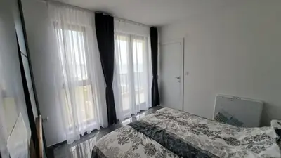 a bedroom with a bed and two large windows at Diamond Beach Luxus Apart Obzor 28 in Obzor